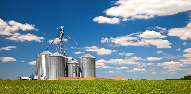 Farm silos sitting in a field, rural America.